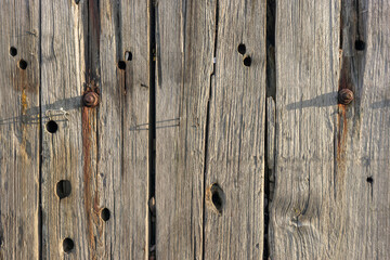 Obraz premium Weathered Harbour Wharf Wall Wood Plank Texture Background with Rusty Bolts and Holes