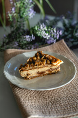 homemade cheesecake with nuts. decorated with flowers on a table at home