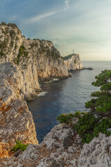 Scenic cliffs and lighthouse near the coast, Lefkada, Greece.