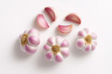 Fresh garlic cloves with pink and white skin arranged on white background, showcasing their unique texture and color. Perfect for culinary use or food photography