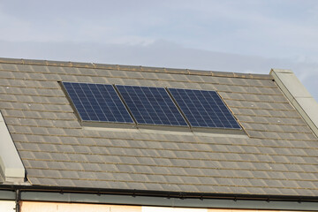 Solar PV Panels on Residential Roof of Modern Apartment House with Energy Efficient Design