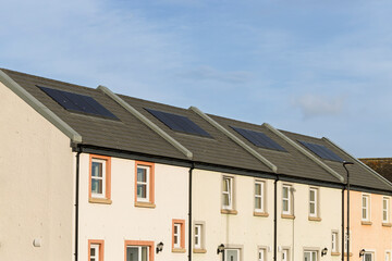 Solar PV Panels on Residential Roof of Modern Apartment House with Energy Efficient Design