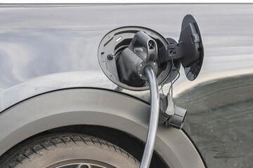 Electric Vehicle Charging Port Cable Plugged in and Connected to EV Car Close-Up