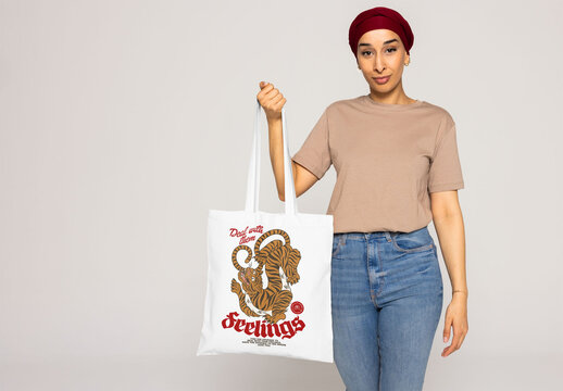 Muslim woman holds an empty tote bag