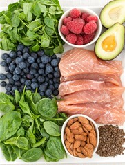 Healthy food platter salmon, berries, greens, nuts.  Use Diet, nutrition, recipe