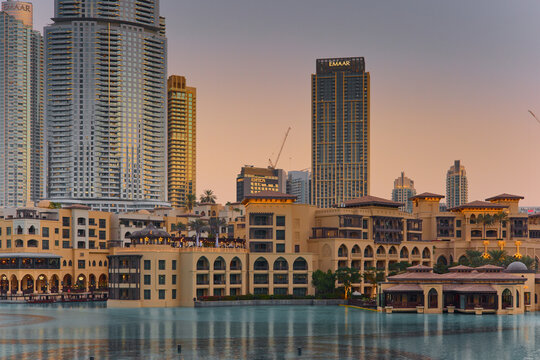 UAE, Dubai, 10 December 2024: a lot of tourists are waiting for the famous dancing fountain show in Dubai next to Souk Al Bahar and the mall at evening, people on embankment