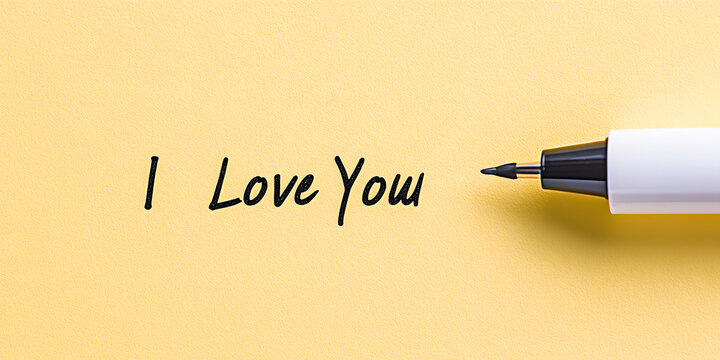 Handwritten message 'I Love You' on a yellow background, next to a pen. A simple, heartfelt message of love and affection. - Powered by Adobe