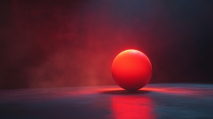 A red ball is sitting on a dark surface