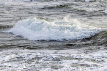 Breaking Ocean Waves at Seaside Shore with White Foam and Spray - Concept of Power, Force, Change, Washing Away, Fleeting Life Experience