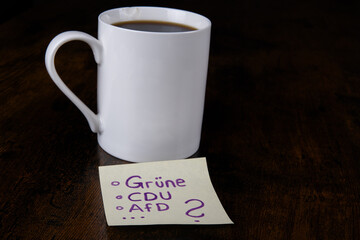 CDU, AFD, Gruene Sticky Note with Coffee Mug.