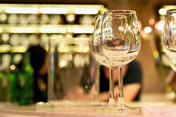 Empty wine glasses on top of a bar