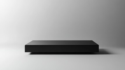 Black rectangular display platform on a gray background with copy space for product presentation or promotional content.