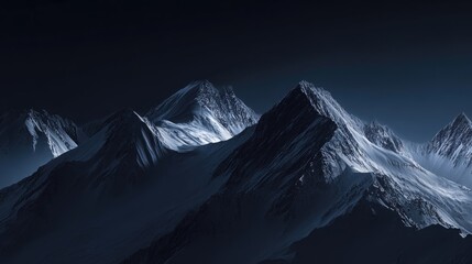 Majestic dark mountain peaks illuminated by soft light against a night sky with copy space for text placement