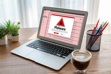 Fototapeta premium Cyber attacking concept. Malware alert showing on computer screen display scam and threat detection on computer system or online server to be removed snugly.