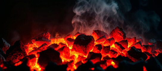 Burning hot coals glowing with intense heat and smoke