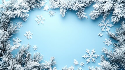 Winter theme with snowflakes and frosted pine branches on blue background Copy Space