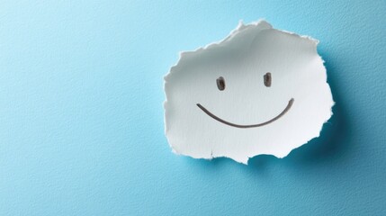 Torn paper with a hand-drawn smiley face on a blue background providing copy space for text placement