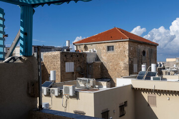 Acre, Israel, January 20, 2025. A view of tiled roofs, solar panels on rooftops, and air conditioners from the balcony of a guesthouse.