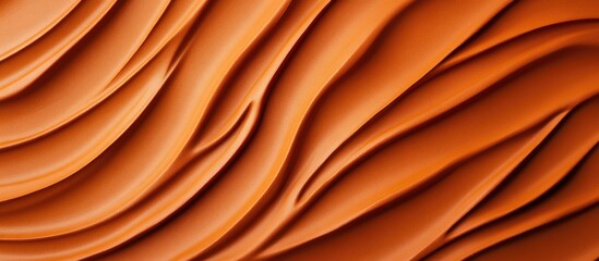 Obraz premium Textured orange fabric background with flowing waves and folds providing ample copy space for design elements.