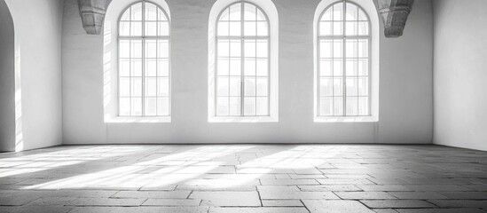 Historic black and white photo of empty interior space with large windows and soft light suitable for text overlay or artistic presentations