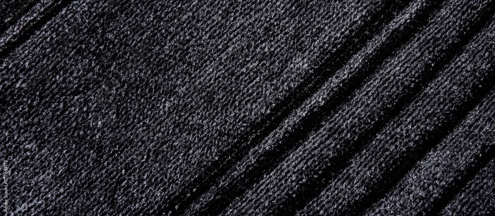 Poster close up of luxurious black velvet fabric textured surface ideal for backgrounds and copyspace for d