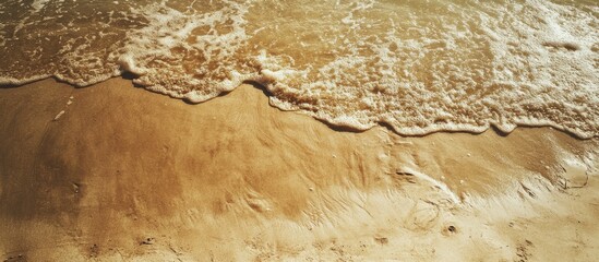 Tranquil beach scene featuring golden sand and gentle waves with ample space for personalized text or branding applications