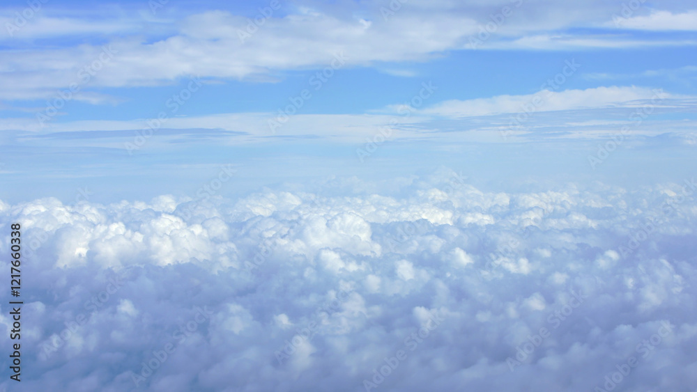 Canvas Prints aerial view of fluffy white clouds with a hint of earth horizon during a flight