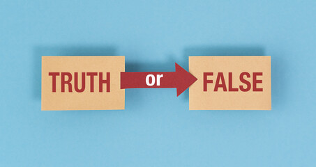 The words Truth or False on paper with question mark symbol. Dilemma or choice between the truth and fake information options.