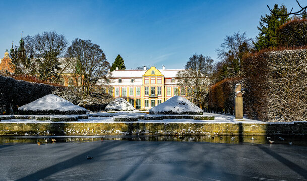 Lawns and architecture in winter Oliwa Park in Gdansk, ancient abbey garden