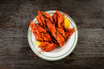 crayfish boiled with lemon on a wooden background