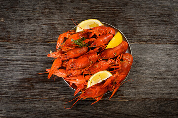 crayfish boiled with lemon on a wooden background