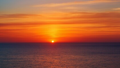 Obraz premium 멀리 수평선 위로 떠오르는 선명한 일출, 붉고 따뜻한 색감의 태양