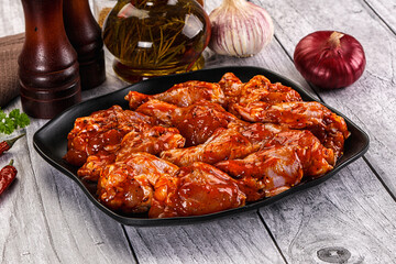 Raw marinated buffalo chicken wings