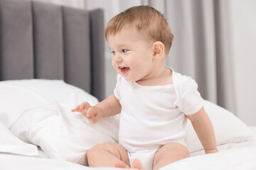 Fototapeta premium Cute little baby on bed at home