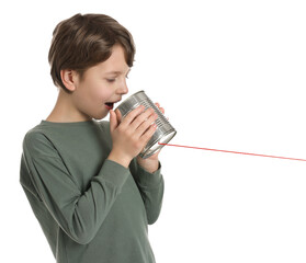 Boy using tin can telephone on white background