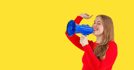 Young woman joyfully using a blue megaphone against a bright yellow background