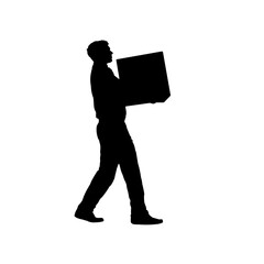 Silhouette of a man carrying a heavy box in front of him