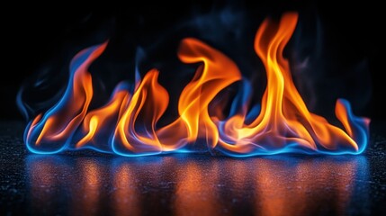 Blue orange flames burning dark surface, studio
