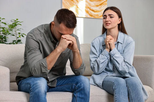 Wife apologizing her husband while he ignoring her at home