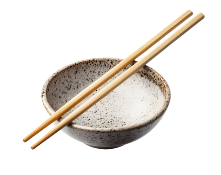 A pair of bamboo chopsticks placed across a speckled ceramic bowl. A minimalist and traditional setup for Asian cuisine dining. Isolated on transparent background, png.