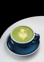 cup with fresh green matcha orange drink. Citrus matcha. Cafe restaurant menu. Black background, place for text. Copy space