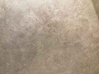 Naklejka premium A low-resolution image of a textured concrete or aggregate wall with muted shades of grey and brown