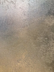 Image shows a blurry, low light condition picture of a textile or fabric with small patterns or dots The color saturation might not be accurate due to poor lighting conditions or angle