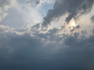 Fototapeta premium View from an elevated perspective of a cloudy, stormy sky with sunlight breaking through, possibly over urban or open landscape