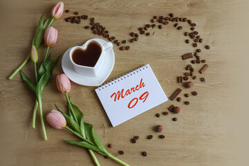 Calendar for March 9: name of the month March in English, numbers 09, cup of tea, tulips, heart made of coffee beans