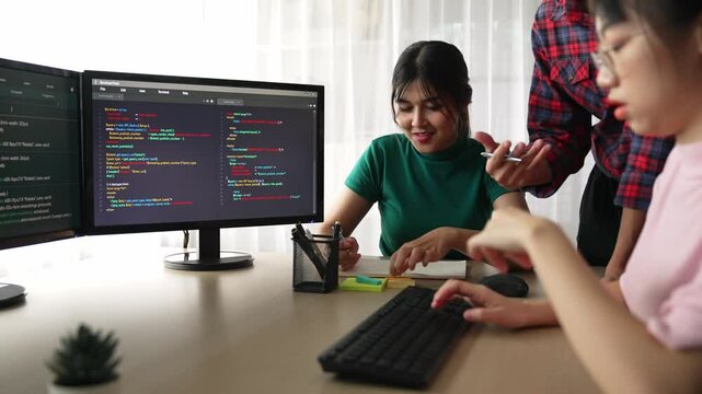 Slow motion back end software developer engineer for computer programming working together on debugging writing computing code, solving complex algorithms display on monitor in office. Burgeoning