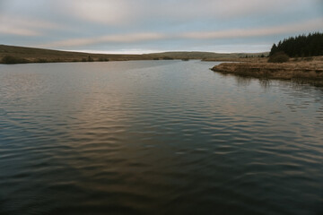 Still Lake with Gentle Ripples Under a Soft Evening Sky