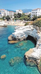 Coastal cove with clear water, white cliffs, and beach.