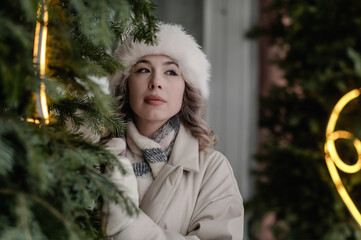 A girl walks through a city decorated for Christmas in winter