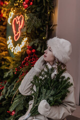 A girl walks through a city decorated for Christmas in winter